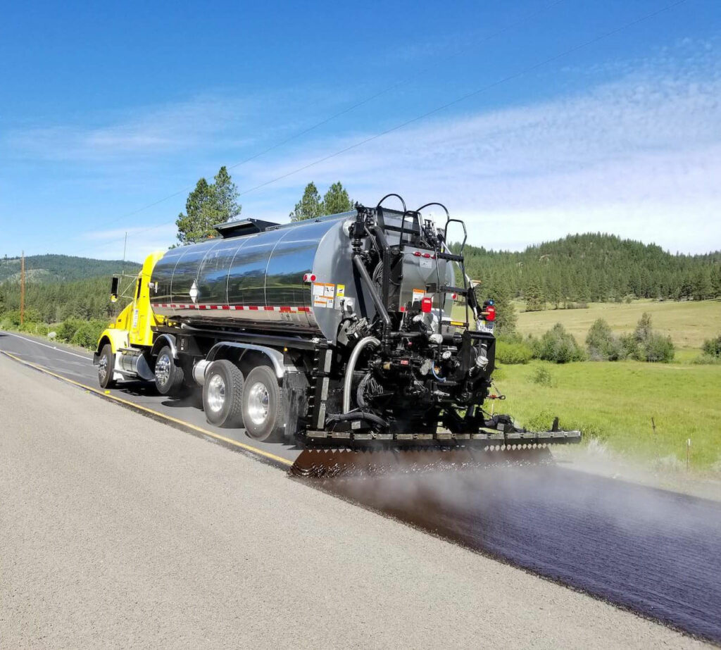 Freshly hot-mix manfactured asphalt being applied to road