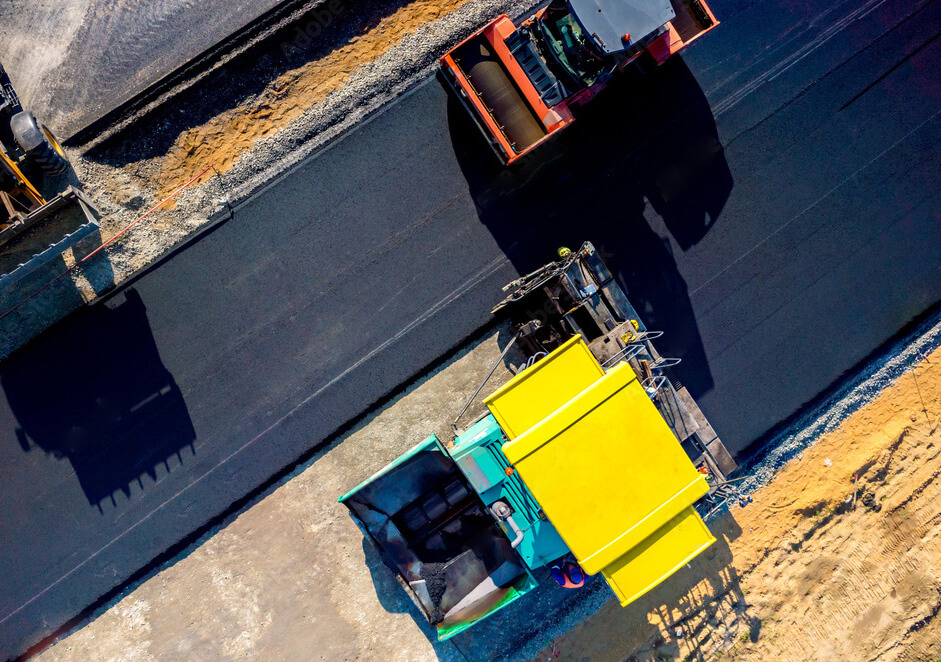 An aerial view of a rod being paved using the rotating equipment sourced by Arroyo Process