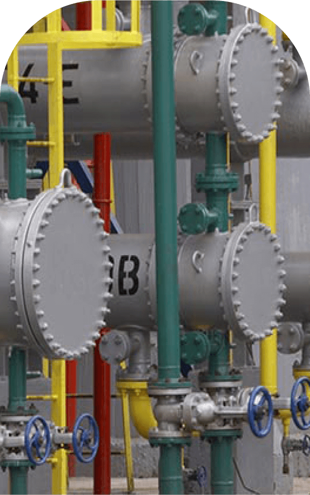 Close-up of industrial heat transfer oil piping system with insulated pipes, valves, and pressure vessels, showcasing the equipment used in managing high-temperature fluids.