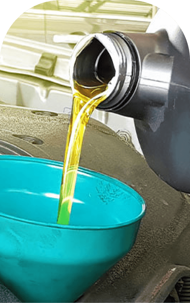 Close-up of lube oil being poured from a container into a blue funnel, illustrating the process of adding lubrication oil to machinery for maintenance.
